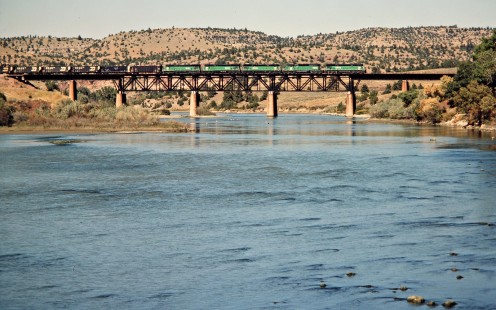 Eastbound Burlington Northern Railroad freight train over North Platte River in Guernsey, Wyoming, on September 30, 1984. Photograph by John F. Bjorklund, © 2015, Center for Railroad Photography and Art. Bjorklund-12-28-21