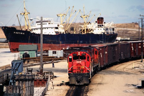 <i>Photinia</i> freighter and Green Bay and Western Railroad freight train in Kewaunee, Wisconsin, on March 1, 1980. Photograph by John F. Bjorklund, © 2015, Center for Railroad Photography and Art. Bjorklund-01-30-01