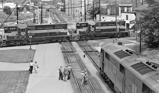 Gulf Mobile & Ohio's northbound <i>Abraham Lincoln</i> passenger train pauses in Bloomington, Illinois, as an eastbound Peoria & Eastern train departs in August 1959. Photograph by J. Parker Lamb, © 2015, Center for Railroad Photography and Art. Lamb-01-066-01