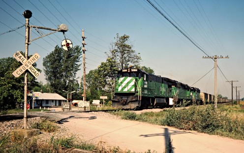 Southbound Burlington Northern Railroad freight train passing a wig-wag crossing signal in Armour, Missouri, on September 24, 1983. Photograph by John F. Bjorklund, © 2015, Center for Railroad Photography and Art. Bjorklund-12-10-08