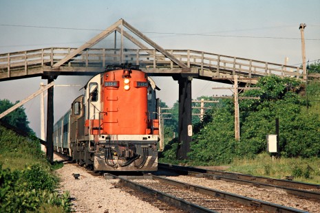 Eastbound Canadian National Railway passenger train behind diesel locomotive no. 3154 in Komoka, Ontario, on June 4, 1977. Photograph by John F. Bjorklund, © 2015, Center for Railroad Photography and Art. Bjorklund-20-15-13