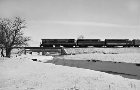 Wabash Railroad eastbound freight train led by locomotives from three different builders passing the village of Sidney, Illinois, en route to Danville on March 11, 1960. Photograph by J. Parker Lamb, © 2015, Center for Railroad Photography and Art. Lamb-01-036-04