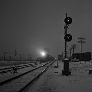 Commuter train at Milwaukee Road's Tower A-20 in Chicago at dusk in March 1959. Photograph by Wallace W. Abbey, © 2015, Center for Railroad Photography and Art. Abbey-04-078-06