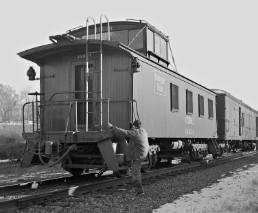 Chicago, Burlington & Quincy Railroad conductor climbing aboard his mixed train at Bushnell, Illinois, for the run to Galesburg on April 14, 1960. Photograph by J. Parker Lamb, © 2015, Center for Railroad Photography and Art. Lamb-01-048-01