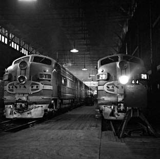Two Santa Fe Railway streamlined passenger trains rest under the shed at Dearborn Station in downtown Chicago on February 2, 1952. Leading both trains are F-series diesel-electric locomotives built by the Electro-Motive Division of General Motors. Photograph by Wallace W. Abbey, © 2015, Center for Railroad Photography and Art. Abbey-02-047-01