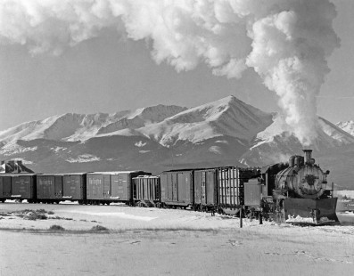 Colorado & Southern 2-8-0 steam locomotive no. 641 switching cars with a snowy Mt. Elbert in background at Leadville, Colorado, on December 13, 1961. Photograph by Ronald C. Hill and available in a limited edition as part of the Center's <a href="http://www.railphoto-art.org/conferences/2016-prints/" rel="nofollow">2016 Print Program</a>.