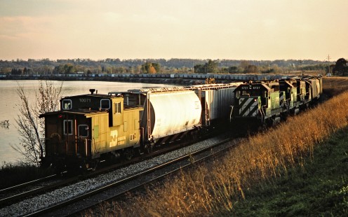 Southbound Burlington Northern Railroad freight train passing a northbound train along the Mississippi River in Montrose, Iowa, on November 2, 1986. Photograph by John F. Bjorklund, © 2015, Center for Railroad Photography and Art. Bjorklund-13-21-16