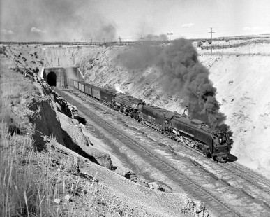 Eastbound Union Pacific freight train emerging from one of the Hermosa tunnels on Wyoming’s Sherman Hill on August 17, 1957. Road power is 4-8-8-4 “Big Boy” no. 4019, assisted by 4-8-4 no. 829 as a headend helper for the climb over the Continental Divide. Photograph by Wallace W. Abbey, © 2015, Center for Railroad Photography and Art. Abbey-04-030-08
