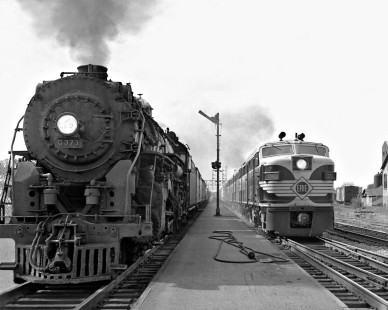 Westbound Erie freight train charges past stopped southbound New York Central passenger train at Marion, Ohio, on September 25, 1955. Photograph by J. Parker Lamb, © 2015, Center for Railroad Photography and Art. Lamb-01-016-08