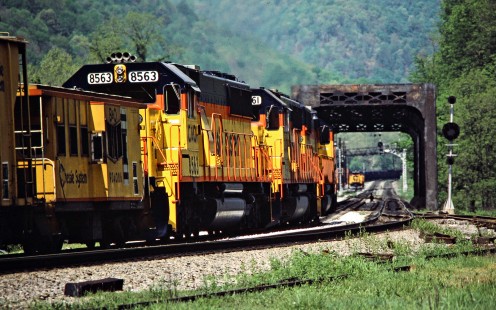Helper locomotives pushing a westbound Baltimore and Ohio Railroad freight train in Rowlesburg, West Virginia, on May 23, 1984. The bridge crosses the Cheat River and M&K Junction is visible beyond it. Photograph by John F. Bjorklund, © 2015, Center for Railroad Photography and Art. Bjorklund-17-06-19