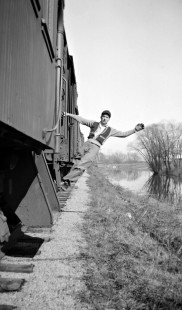 Grand Trunk Western Railroad worker Bill Miller on caboose steps at Pigeon, Michigan, in 1946; Photograph by Robert Hadley; Hadley-05-010-02.JPG; © 2017, Center for Railroad Photography and Art