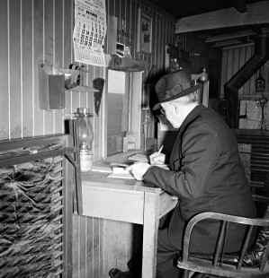 Grand Trunk Western Railroad conductor Frank Mapley at desk in Richmond, Michigan, circa 1940. Photograph by Robert Hadley; Hadley-04-109-04.JPG; © 2016, Center for Railroad Photography and Art