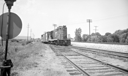 Grand Trunk Western Railroad diesel locomotive no. 4138 leads freight train at Dryden, Michigan, circa 1965. Photograph by Robert Hadley; Hadley-05-004-04.JPG; © 2017, Center for Railroad Photography and Art