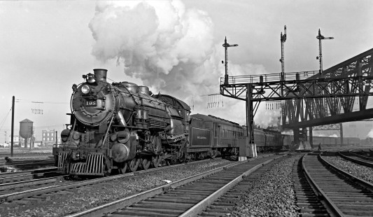 Reading Company 4-6-2 steam locomotive no. 105 pulling westbound passenger train no. 1613, the "Philadelphia Express," at Jersey City, New Jersey, on December 10, 1939. Furler-08-038-01