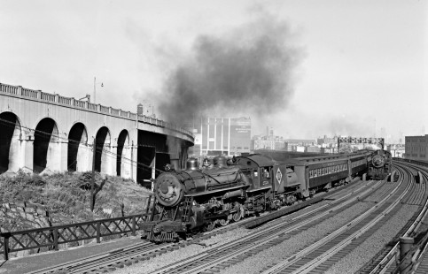 Erie Railroad 4-6-2 steam locomotives nos. 2526 and 2521 leading westbound passenger trains out of Jersey City, New Jersey, circa 1950. Photograph by Donald W. Furler, © 2017, Center for Railroad Photography and Art, Furler-19-096-01