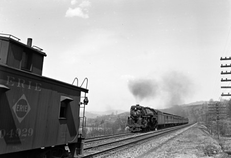 Erie Railroad 4-6-2 steam locomotive no. 2940 pulling a passenger east of Gulf Summit, New York, on April 20, 1941. The passenger train appears to be overtaking a freight train whose caboose is visible on the adjacent track. Photograph by Donald W. Furler, © 2017, Center for Railroad Photography and Art, Furler-10-019-01