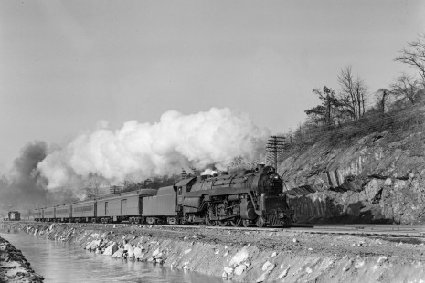 Reading Company 4-6-2 steam locomotive no. 211 leading an eastbound passenger train along the Lehigh Coal & Navigation Company canal at Bethlehem, Pennsylvania, on January 13, 1952. Note the diesel switch engine and caboose in the distance. Photograph by Donald W. Furler, © 2017, Center for Railroad Photography and Art, Furler-19-008-01