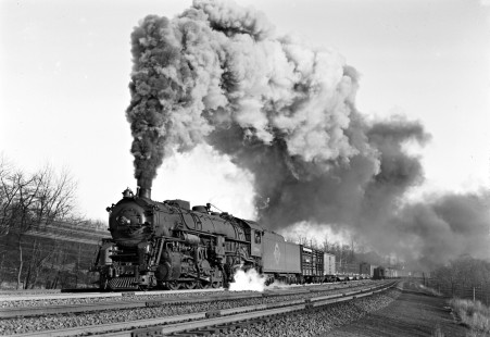 Erie Railroad 2-8-4 steam locomotive no. 3380 pulling a westbound freight train with 106 cars at Waldwick, New Jersey, on February 13, 1947. Passenger train no. 12, which had locomotive no. 3203, is just disappearing around the distant curve. Photograph by Donald W. Furler, © 2017, Center for Railroad Photography and Art, Furler-11-061-02