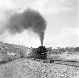 National Railways of Mexico steam locomotive no. 2037 hauls freight through tunnel 15 miles north of Terminal del Valle de Mexico in Tlalnepantla de Bas, State of Mexico, Mexico in August or September of 1961. The train carries oil to fire the kilns of the cement plant at Tula de Allende. Rose-01-074-07; Photograph by Ted Rose, © 2015, Center for Railroad Photography and Art
