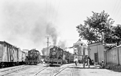 Mexican Railway 2-8-0 no. 67 moves down the track switching and 2-8-0 no. 277 takes in oil at yard in Cuautla, Morelos, Mexico on August 24, 1961. Rose-01-200-33; Photograph by Ted Rose,  © 2015, Center for Railroad Photography and Art
