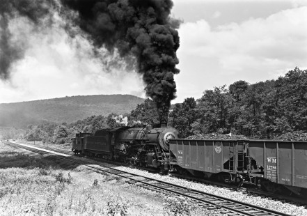 Western Maryland Railway steam locomotive no. 1112 pushes an eastbound coal train of 100 cars near the summit at Deal Pennsylvania, circa 1952. Furler-22-084-02; © 2017, Center for Railroad Photography and Art