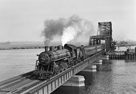 Erie Railroad 4-6-2 steam locomotive no. 2552 leading a westbound passenger train no. 123 over the Hackensack River Drawbridge (HX) between Croxton Yard and Rutherford, New Jersey on August 2, 1951. Photograph by Donald W. Furler, © 2017, Center for Railroad Photography and Art, Furler-19-113-01