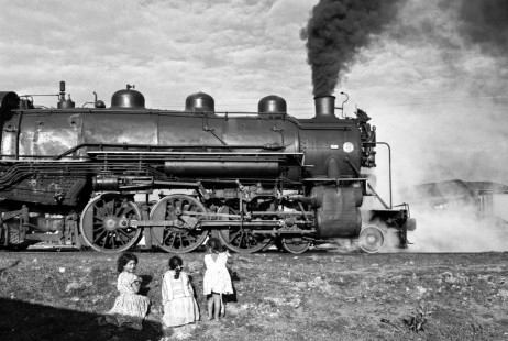 National Railways of Mexico 4-6-2 steam locomotive 2530 gets westbound tonnage out of Toluca on September 8, 1961. Small children watch the train in profile. Rose-01-126-09; Photograph by Ted Rose,  © 2015, Center for Railroad Photography and Art