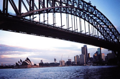 A view of the Sydney Harbour Bridge,  which carries rail, bike and pedestrian traffic from the central business district to the North Shore, in Sydney, New South Wales, Australia, on April 16, 1998. The Sydney Opera House is visible in the distance. Photograph by Fred M. Springer, © 2014, Center for Railroad Photography and Art. Springer-Australia-18-05