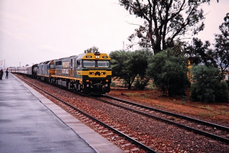 Freight Australia (now Pacific National) diesel locomotive no. V544 is the leading a long train past several onlookers at the platform in Port Augusta, South Australia, Australia, on April 12, 2003. Photograph by Fred M. Springer, © 2014, Center for Railroad Photography and Art. Springer-Australia-NZ(2)-02-36