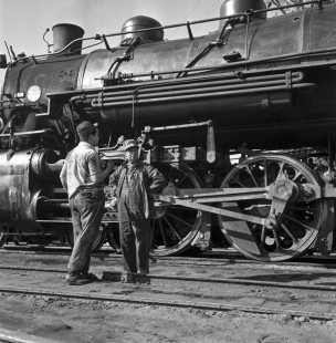 National Railways of Mexico 4-6-2 steam locomotive no. 2530 being serviced by two workers at Acambaro, Guanajuato, Mexico in September, 1961. Rose-01-069-06; Photograph by Ted Rose,  © 2015, Center for Railroad Photography and Art