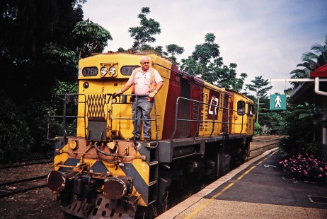 A man looks out at the nearby platform as he rides aboard the Kuranda Scenic Railway diesel locomotive no. 1761 in Kuranda, Queensland, Australia, on April 21, 1998. Photograph by Fred M. Springer,  © 2014, Center for Railroad Photography and Art. Springer-Australia-24-21
