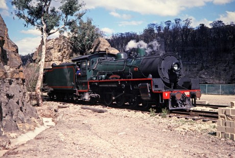 The Zig Zag Railway no. 1072 or "City of Lithgow" maneuvers between two rock formations in Sydney, New South Wales, Australia, on April 17, 1998. The Zig Zag Railway is Australian Heritage railroad near Lithgow in New South Wales. Photograph by Fred M. Springer, © 2014, Center for Railroad Photography and Art. Springer-Australia-19-16