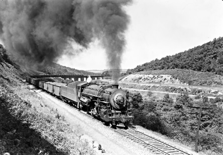 Western Maryland Railway steam locomotive no. 1117 hauls coal eastward at Meyersdale, Pennsylvania in August of 1952. The bridge in the background crosses the Baltimore & Ohio Railroad's main line. Furler-16-005-01; © 2017, Center for Railroad Photography and Art