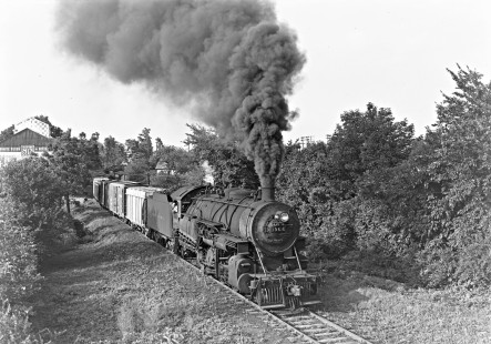 Reading Company 2-8-0 steam locomotive no. 1966 with an eastbound freight train passes through Maiden Creek, Pennsylvania on the Shuykill and Lehigh branch en route to the city of Reading, circa 1950. Maiden Creek Farm Supply is visible on the left side of the image. Thanks to Robert Wanner for helping to identify this image! Photograph by Donald W. Furler, © 2017, Center for Railroad Photography and Art, Furler-19-029-02