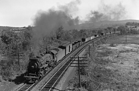 Erie Railroad 2-8-2 steam locomotive no. 3129 leading a freight train at an un-noted location (please comment if you know where this is), circa 1950. Photograph by Donald W. Furler, © 2017, Center for Railroad Photography and Art, Furler-20-094-02