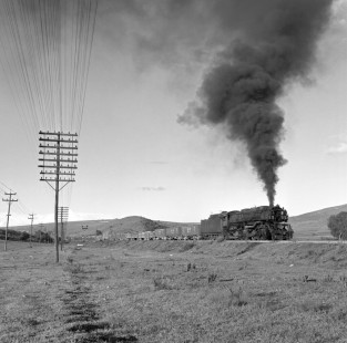 National Railways of Mexico 2-6-6-2 steam locomotive no. 2032 leads a freight train 15 miles north of Terminal del Valle de Mexico (in Tlalnepantla de Baz, State of Mexico) on the busy main line to the north tunnel through. Rose-01-082-01; Photograph by Ted Rose,  © 2015, Center for Railroad Photography and Art