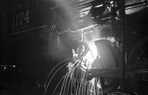 Welder working on the frame of National Railways of Mexico steam locomotive no. 1174 in shop at Aguascalientes, State of Aguascalientes, Mexico on September 11, 1961. Rose-01-204-02; Photograph by Ted Rose, © 2015, Center for Railroad Photography and Art