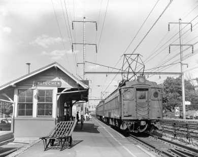Pennsylvania Railroad multiple unit (MU) electric car no. 4205 next to Metuchen depot with passenger train in Metuchen, New Jersey, on May 19, 1963. Photograph by Victor Hand. Hand-PRR-32-006