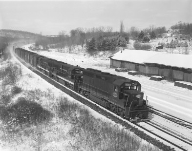 New York Central Railroad diesel locomotive no. 3064 hauls an eastbound freight train in Palmyra, New York, on February 23, 1968. Photograph by Victor Hand. Hand-NYC-PC-CR-31-0124