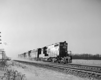 New York Central Railroad diesel locomotive no. 6053 leads eastbound freight near Byron, New York, on December 29, 1963. Photograph by Victor Hand. Hand-NYC-PC-CR-31-0008