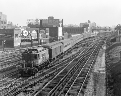 New York Central Railroad electric locomotive no. 280 with passenger train no. 65, the "Henry Hudson," in the Mott Haven neighborhood in New York City, New York on May 15, 1965. Photograph by Victor Hand. Hand-NYC-PC-CR-31-0033