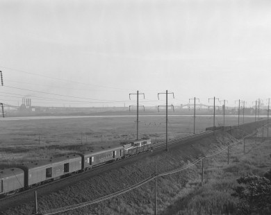 Pennsylvania Railroad GG1 electric locomotive no. 4922 leads westbound passenger train no. 3 near Snake Hill in Secaucus, New Jersey, on July 21, 1965. Photograph by Victor Hand. Hand-PRR-32-056