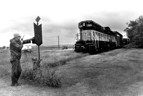 Wayne ''Jake" Jacobs communicates with a radio on June 15, 1982, while his Milwaukee Road train switches cars at a farm supply company west of Prairie du Sac. He worked as a brakeman and later as a conductor from 1946 to 1985.