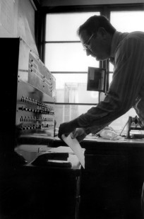Arnold Sturm works for the Milwaukee Road in its office in Portage, Wisconsin, where Canadian Pacific freight trains change crews today. When the photograph was taken in the 1980s, Sturm prepared train orders (instructions written on thin sheets of paper so carbon copies could be made) and operated switches for a junction about one mile away. Sturm, a fourth generation Milwaukee Roader, went to work for the railroad in 1966.