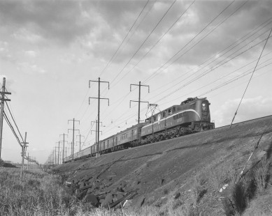 Pennsylvania Railroad GG1 electric locomotive no. 4910 hauls westbound passenger train no. 3 in Secaucus, New Jersey, on July 20, 1965. Photograph by Victor Hand. Hand-PRR-32-052