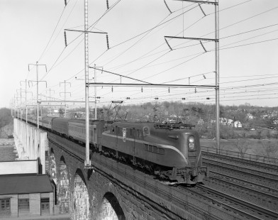 Pennsylvania Railroad GG1 electric locomotive no. 4908 pulls westbound passenger train no. 113, the <i> Silver Meteor </i> across the Raritan River Bridge in New Brunswick, New Jersey, on March 19, 1964. Photograph by Victor Hand. Hand-PRR-32-022