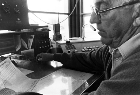 Jim Reidelbach, an operator at Portage, Wisconsin, demonstrates the telegraph key in 1983, the time-honored manner of communicating on the railroad. Although the company used telephones for most business, the Milwaukee Road kept a telegraph line in service along its main line for emergency use through the mid-1980s, far longer than on most railroads. The Chicago & North Western discontinued its telegraph line at Madison in 1967.