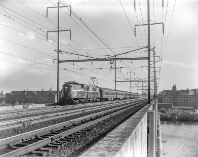 Pennsylvania Railroad GG1 electric locomotive no. 4935 leads eastbound "Clocker" train no. 220 over the Raritan River Bridge in New Brunswick, New Jersey, on May 19, 1963. Photograph by Victor Hand. Hand-PRR-32-011