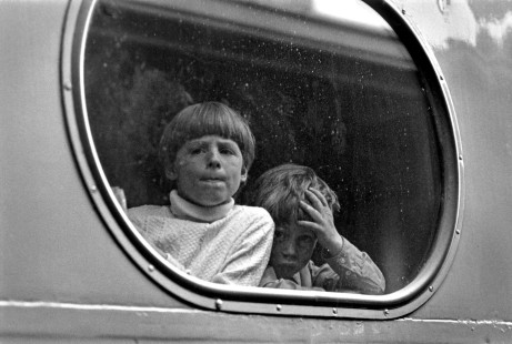 Richard and Timothy Gruber, sons of photographer John Gruber, peer out the window of a Miwaukee Road passenger train.