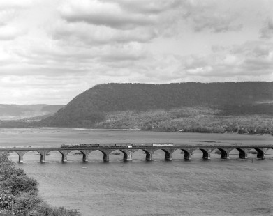 Penn Central diesel locomotive no. 4278, still wearing paint of predecessor Pennsylvania Railroad, leads westbound  passenger train no. 25, the <i>Duquesne,</i> across the Rockville Bridge over the Susquehanna River October 21, 1968.. The bridge connects Rocksville and Marysville, Pennsylvania. Photograph by Victor Hand. Hand-PRR-32-113